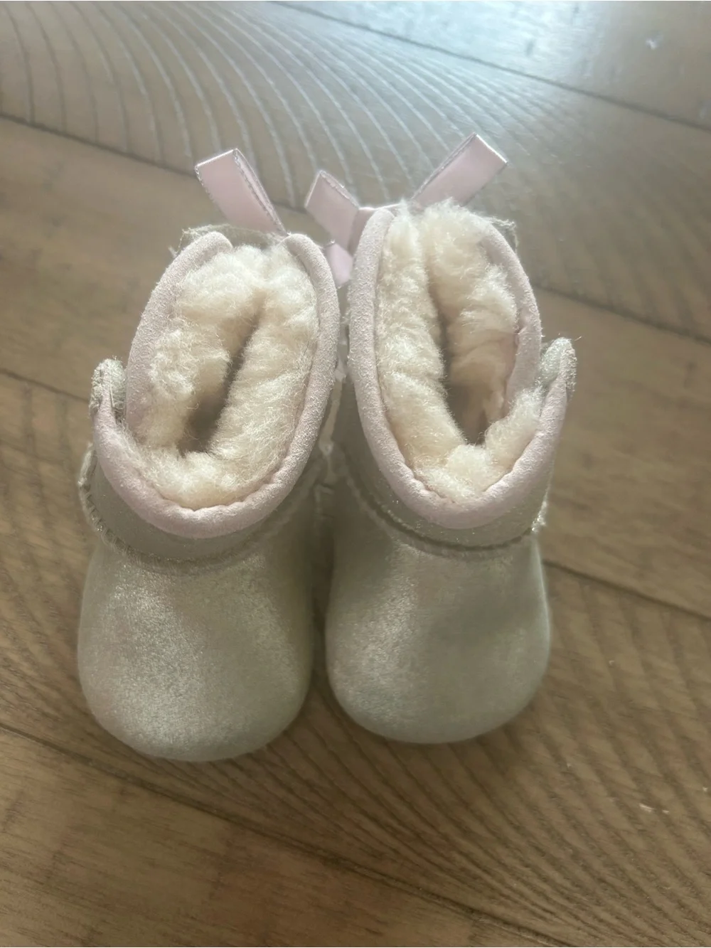 Size 0/1 UGG booties with bow